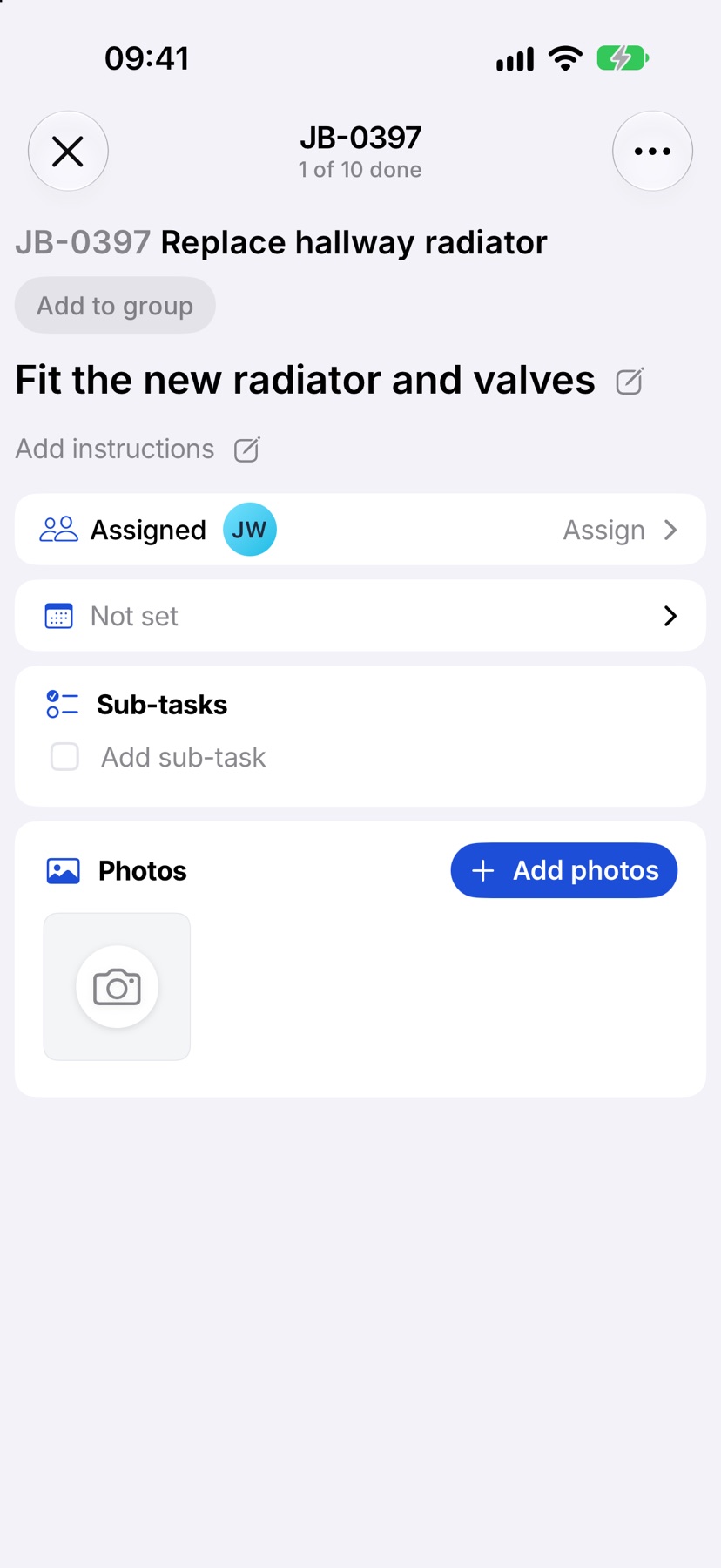 A task opened, with its Photos section and the Add photos button